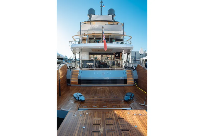 Slide: The Image of Sleek Sirena 118 yacht, 2027 model, featuring elegant wooden deck and modern design. - 6