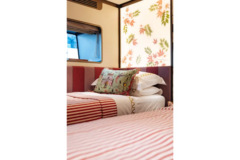 Slide: The Image of Luxurious Sirena 118 yacht bedroom with patterned bedding and decorative wall panel, 2027 model. - 25