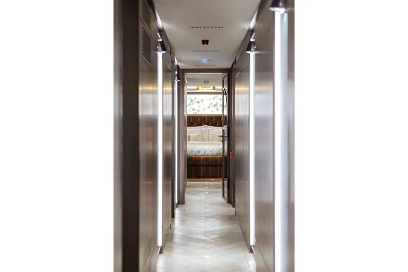 Slide: The Image of Narrow hallway in Sirena 118 yacht, 2027 model, leading to a luxurious bedroom. - 23