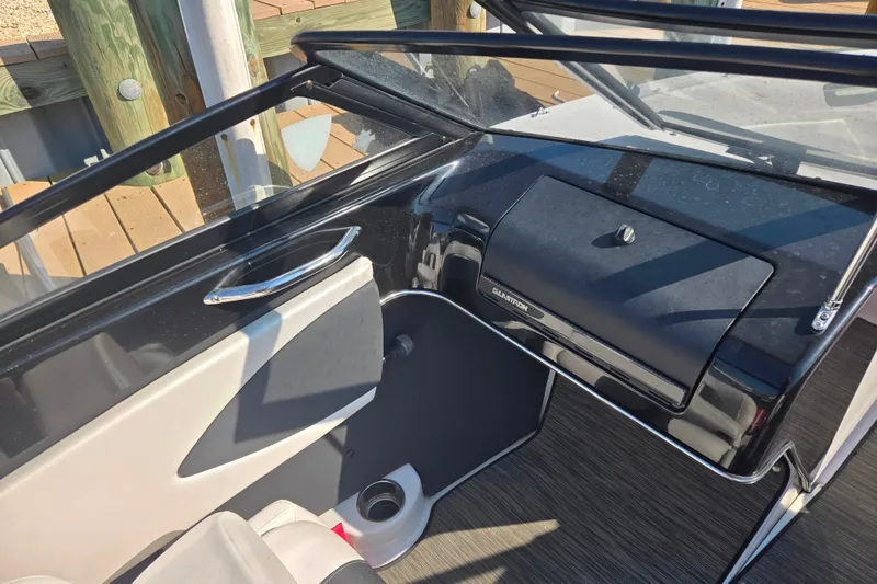 Slide: The Image of 2018 Glastron GTS 180 boat interior with dashboard and seating area. - 3