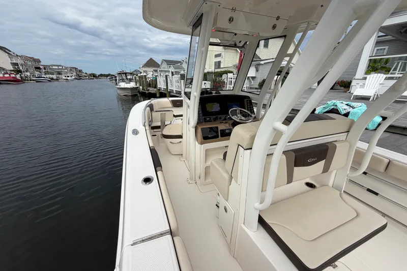 Slide: The Image of 2020 Robalo R272 Center Console boat docked in a scenic waterfront neighborhood. - 36