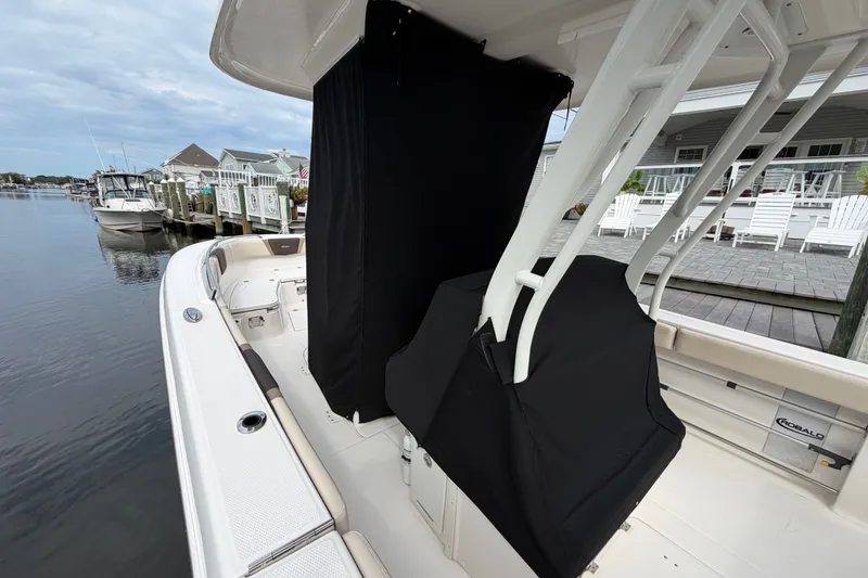 Slide: The Image of 2020 Robalo R272 Center Console boat docked by waterfront homes. - 58
