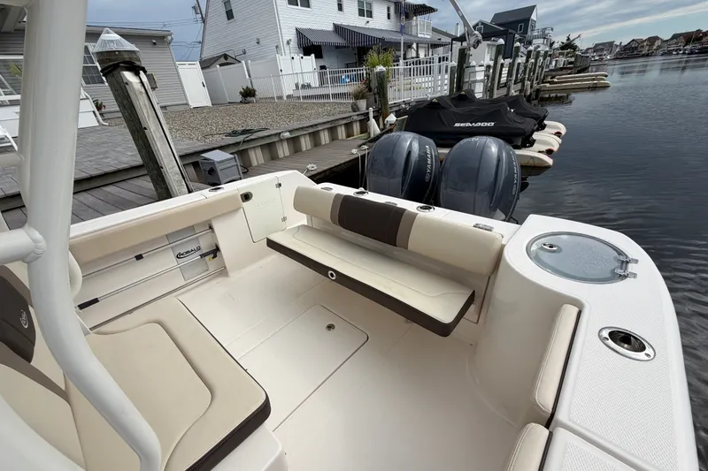 Slide: The Image of 2020 Robalo R272 Center Console boat docked, featuring spacious seating and twin Yamaha engines. - 29