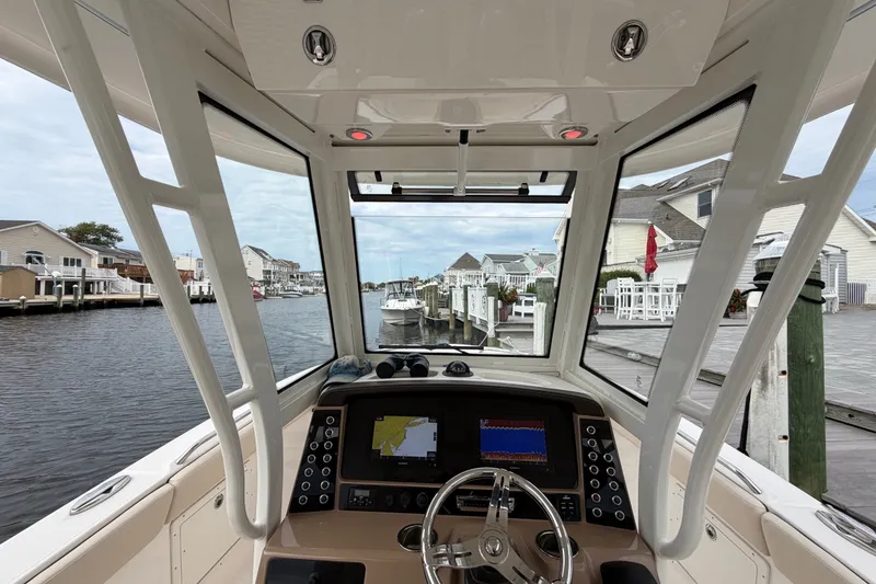 Slide: The Image of 2020 Robalo R272 Center Console boat interior with navigation system, docked at marina. - 39