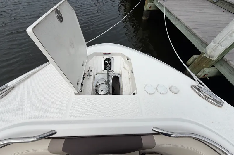 Slide: The Image of 2020 Robalo R272 Center Console boat anchor compartment at dockside. - 49