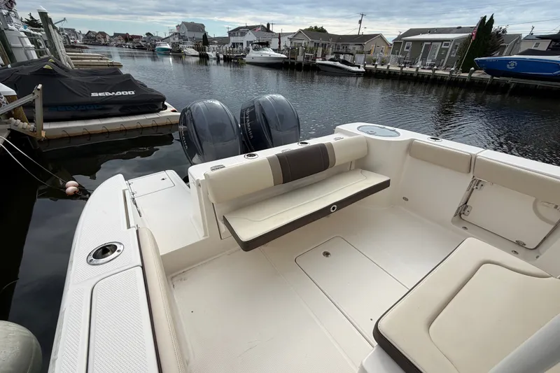 Slide: The Image of 2020 Robalo R272 Center Console boat docked in a serene marina setting. - 30
