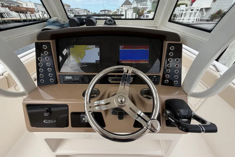 Slide: The Image of 2020 Robalo R272 Center Console helm with navigation screens and controls. - 38
