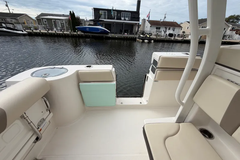 Slide: The Image of 2020 Robalo R272 Center Console boat interior by a waterfront dock. - 32