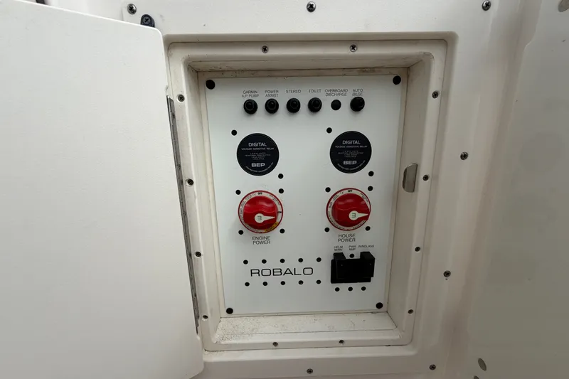 Slide: The Image of Control panel of a 2020 Robalo R272 Center Console boat, featuring power switches and indicators. - 55