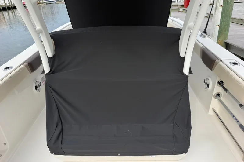 Slide: The Image of 2020 Robalo R272 Center Console boat with black console cover at dock. - 60