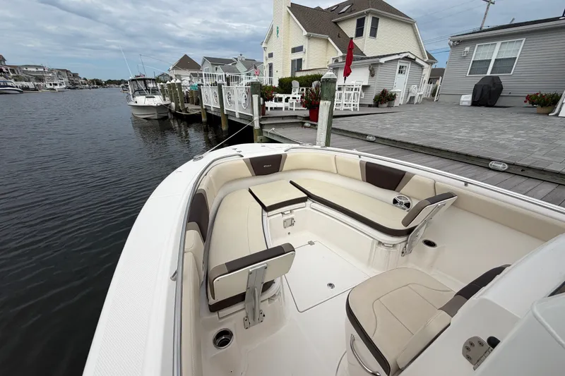 Slide: The Image of 2020 Robalo R272 Center Console boat docked by waterfront homes. - 45