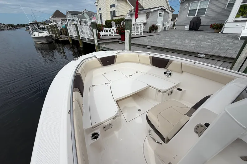 Slide: The Image of 2020 Robalo R272 Center Console boat docked by waterfront homes. - 53