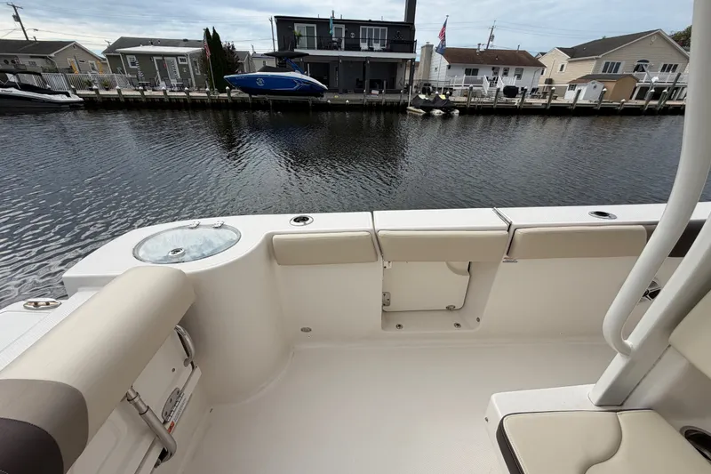 Slide: The Image of 2020 Robalo R272 Center Console boat interior with waterfront view. - 31