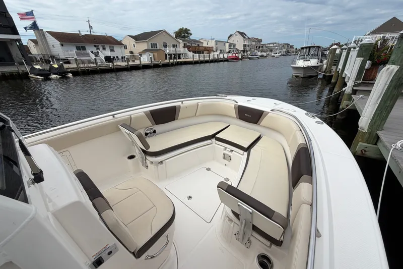 Slide: The Image of 2020 Robalo R272 Center Console boat with spacious seating, docked in a marina. - 44