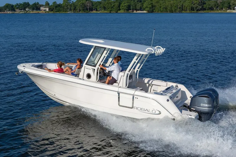 Slide: The Image of Manufacturer Provided Image: 2020 Robalo R272 Center Console boat cruising on a lake with passengers. - 2