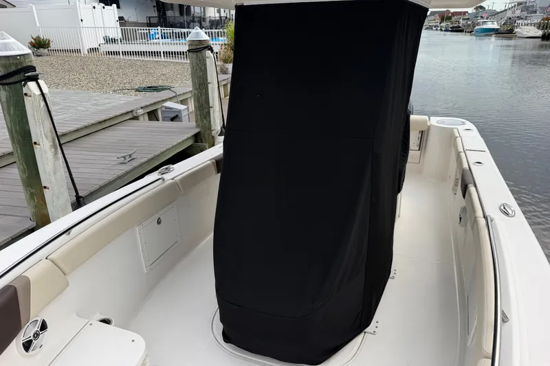 Slide: The Image of 2020 Robalo R272 Center Console boat docked, featuring covered console area. - 56