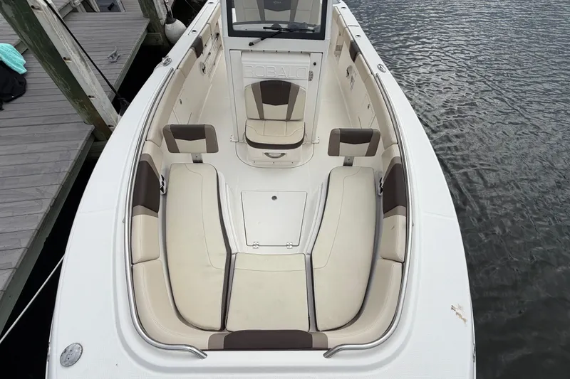 Slide: The Image of 2020 Robalo R272 Center Console boat with spacious seating, docked by the water. - 46