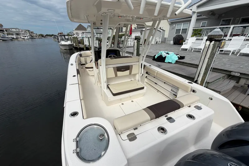 Slide: The Image of 2020 Robalo R272 Center Console boat docked, featuring spacious seating and modern design. - 25