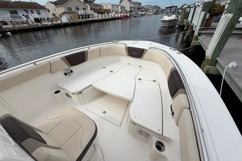 Slide: The Image of 2020 Robalo R272 Center Console boat with spacious seating and storage, docked in a marina. - 52