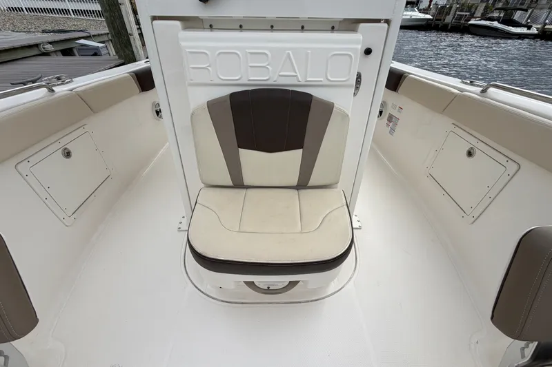 Slide: The Image of 2020 Robalo R272 Center Console boat interior with cushioned seating and storage compartments. - 50