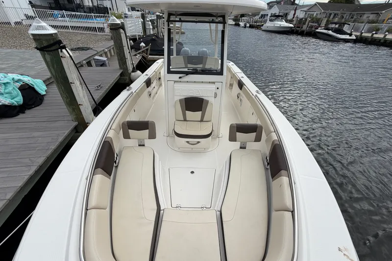 Slide: The Image of 2020 Robalo R272 Center Console boat docked by the water. - 47