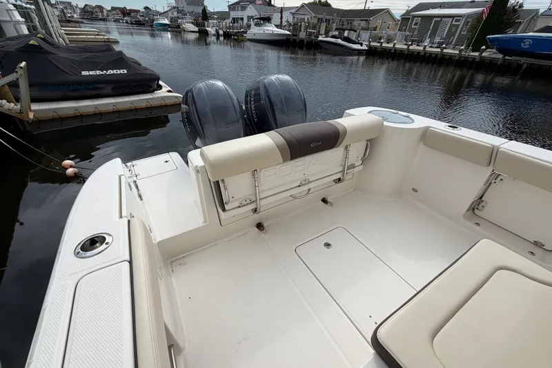 Slide: The Image of 2020 Robalo R272 Center Console boat with dual engines docked in a marina. - 26