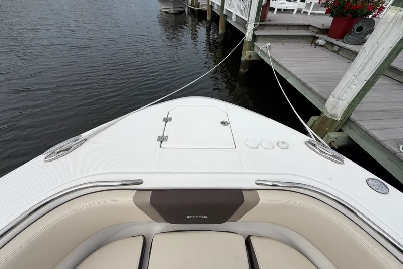 Slide: The Image of 2020 Robalo R272 Center Console boat docked at a marina. - 48