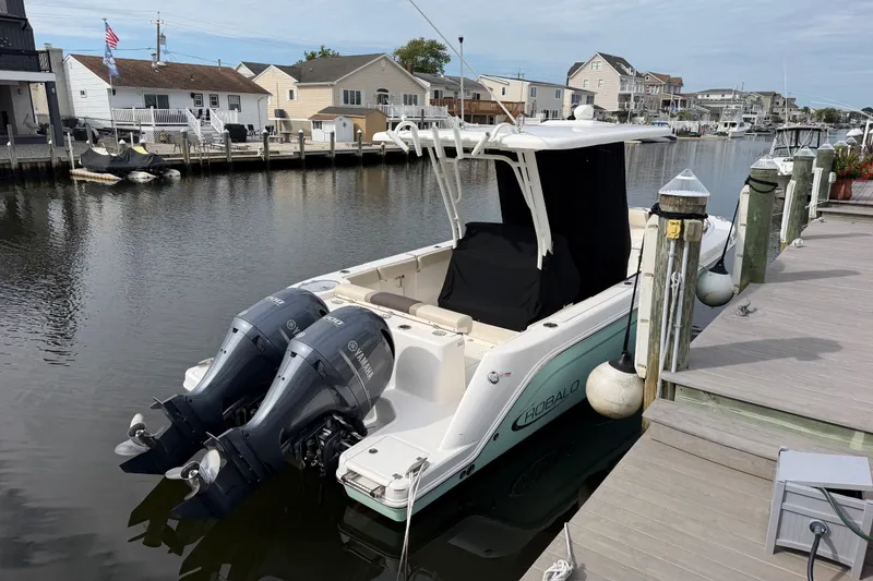Slide: The Image of 2020 Robalo R272 Center Console boat docked with twin Yamaha engines. - 23