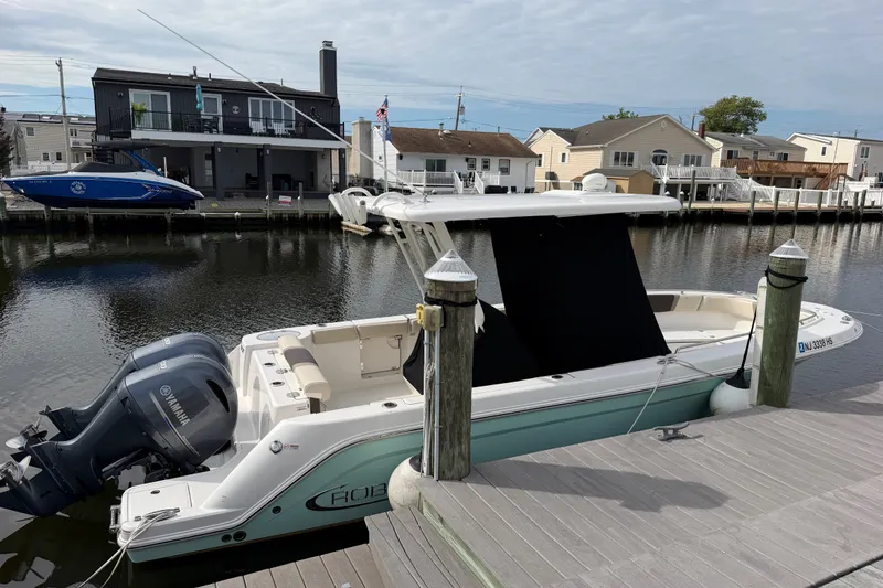 Slide: The Image of 2020 Robalo R272 Center Console boat docked by waterfront homes. - 21
