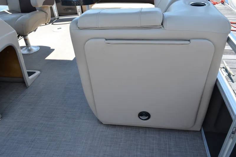 Slide: The Image of 2019 Sun Tracker Fishin' Barge 20 DLX interior with beige seating and flooring. - 14