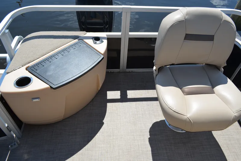 Slide: The Image of 2019 Sun Tracker Fishin' Barge 20 DLX interior with beige seating and fishing station. - 20