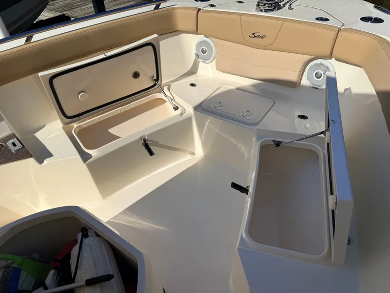 Slide: The Image of The image shows the cockpit of a 2018 Scout 235 XSF boat with storage compartments. - 4