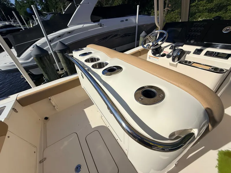 Slide: The Image of The image shows the cockpit of a 2018 Scout 235 XSF boat with sleek details. - 10