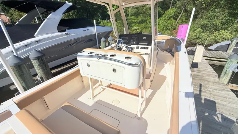 Slide: The Image of The image shows a 2018 Scout 235 XSF boat docked at a pier. - 9