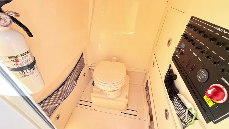 Slide: The Image of Interior of a 2018 Scout 235 XSF featuring a toilet and control panel. - 19