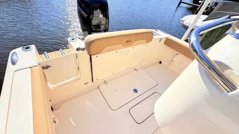 Slide: The Image of The image shows the cockpit of a 2018 Scout 235 XSF boat with an outboard motor. - 8