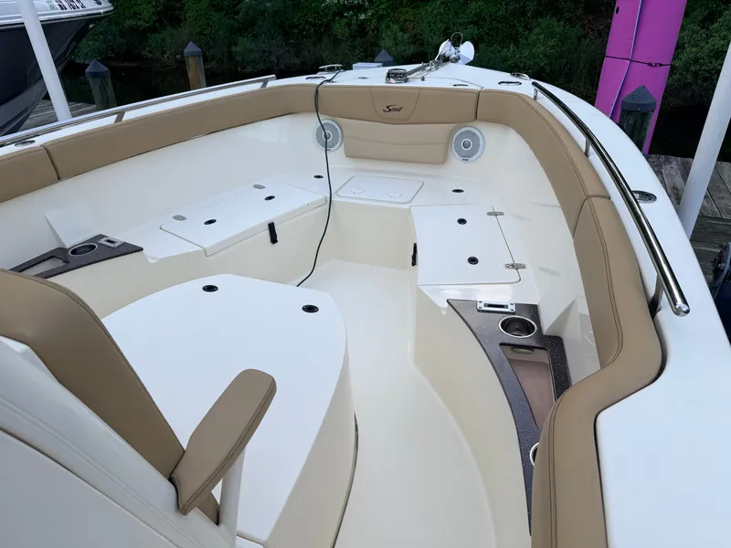 Slide: The Image of The image shows the cockpit of a 2018 Scout 235 XSF boat with beige upholstery. - 3