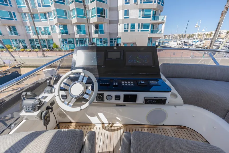 Slide: The Image of Cockpit of 2021 Azimut Fly 60 yacht with modern navigation controls and luxurious seating. - 22