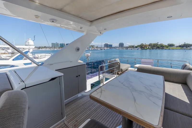 Slide: The Image of Luxurious 2021 Azimut Fly 60 yacht deck with elegant seating and scenic marina view. - 27