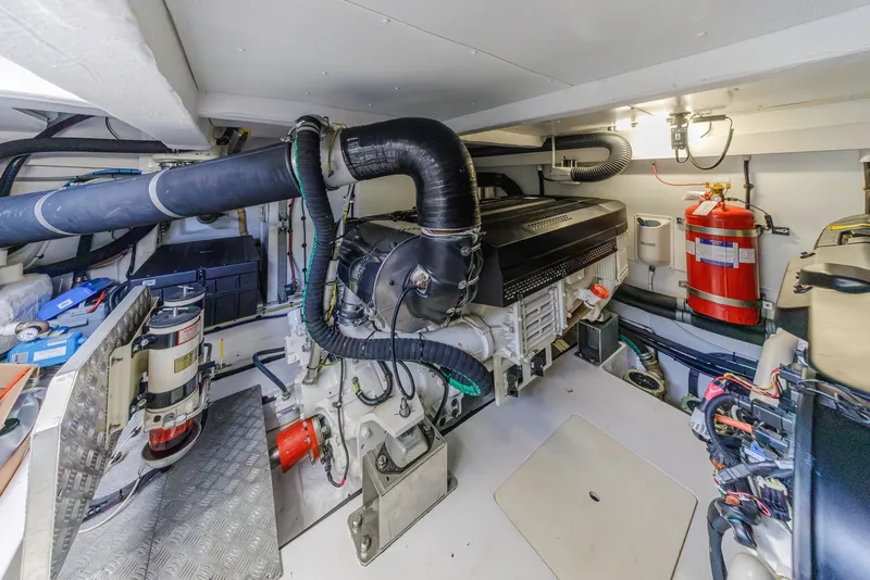 Slide: The Image of Engine room of 2021 Azimut Fly 60 yacht, featuring modern equipment and fire extinguisher. - 65