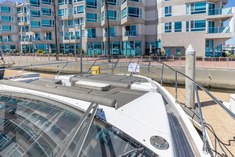 Slide: The Image of Azimut Fly 60 yacht docked near modern waterfront apartments, 2021 model. - 32
