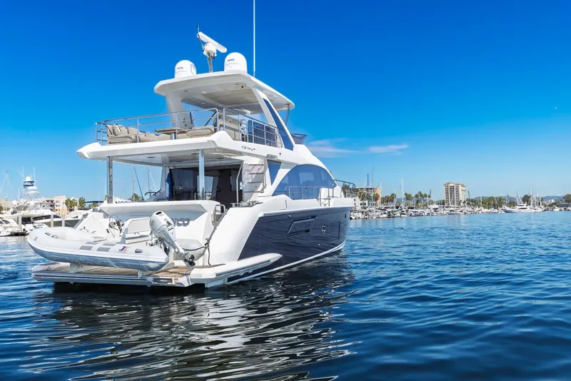 Slide: The Image of Luxury 2021 Azimut Fly 60 yacht docked in a sunny marina setting. - 3