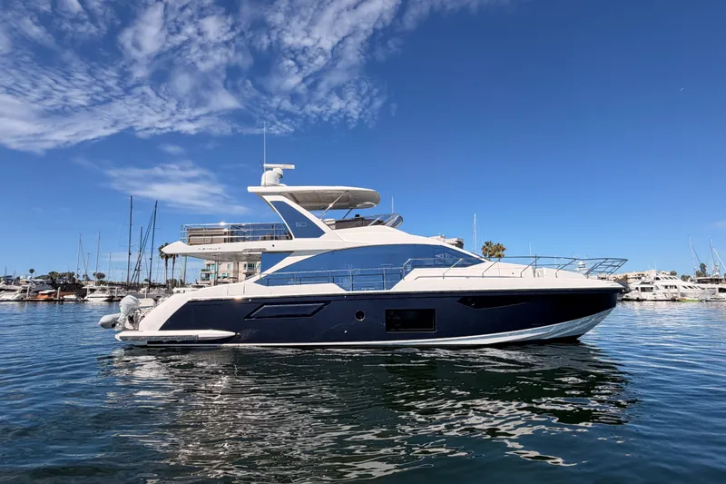 Slide: The Image of 2021 Azimut Fly 60 yacht docked in a marina under a clear blue sky. - 8