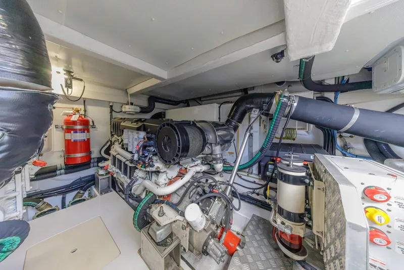 Slide: The Image of Engine room of 2021 Azimut Fly 60 yacht, featuring advanced machinery and fire safety equipment. - 64