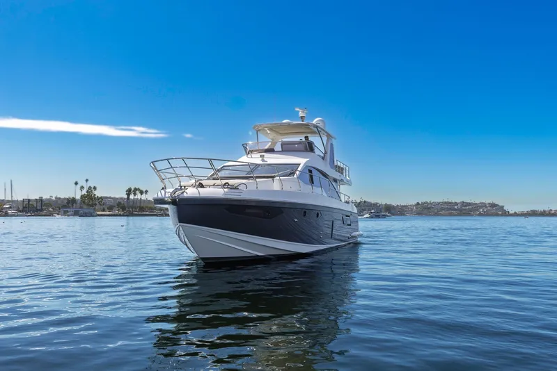 Slide: The Image of Azimut Fly 60 yacht from 2021 on calm waters under a clear blue sky. - 7