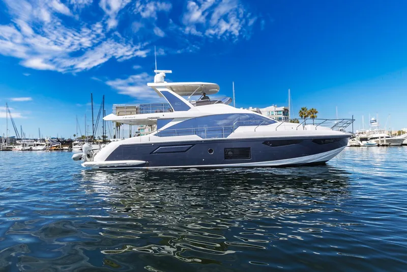 Slide: The Image of Luxury Azimut Fly 60 yacht from 2021 docked in a marina under clear blue skies. - 4