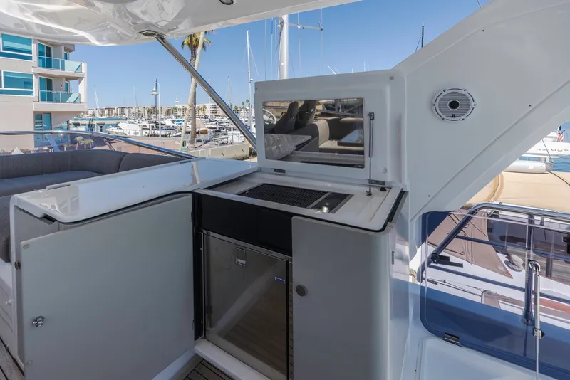 Slide: The Image of Outdoor kitchenette on 2021 Azimut Fly 60 yacht, featuring grill and marina view. - 19