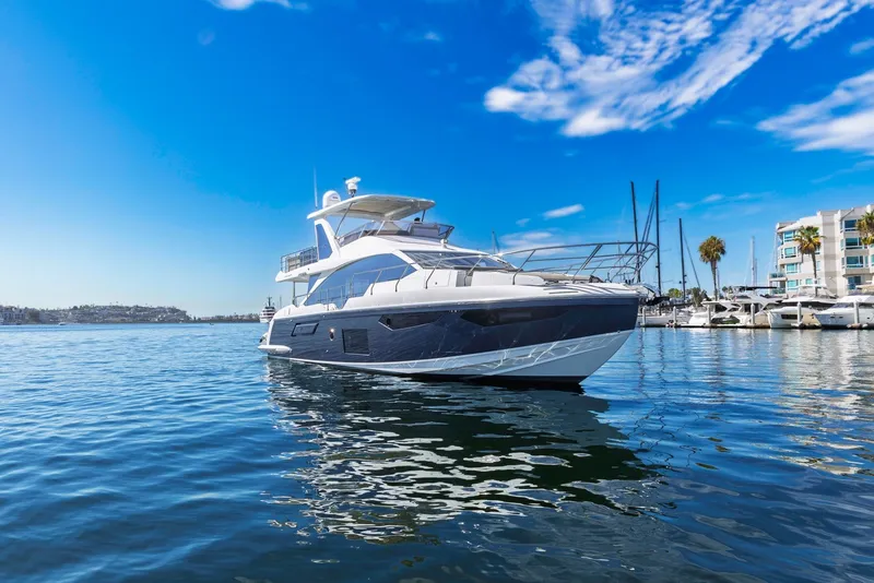 Slide: The Image of Luxury 2021 Azimut Fly 60 yacht on serene blue waters under clear sky. - 5
