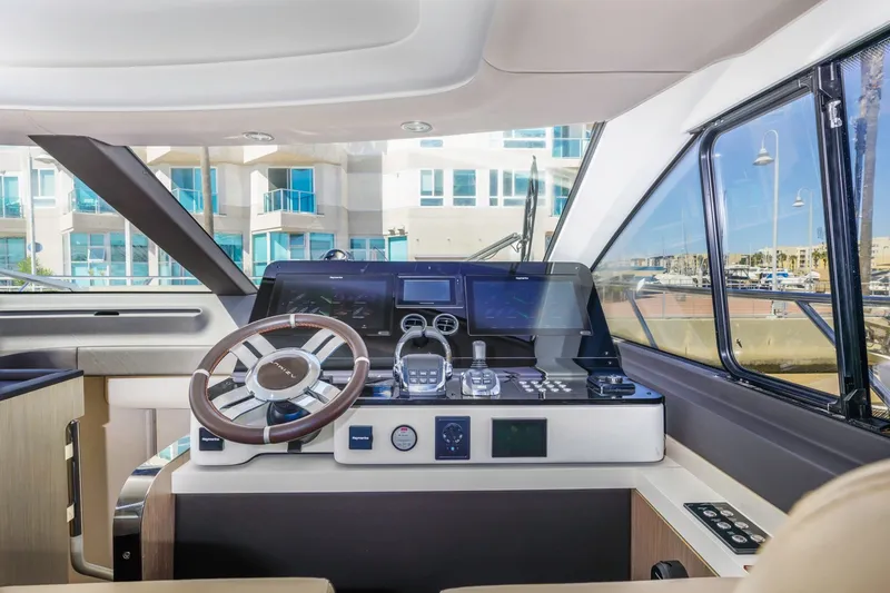 Slide: The Image of Interior helm of 2021 Azimut Fly 60 yacht with modern controls and steering wheel. - 42