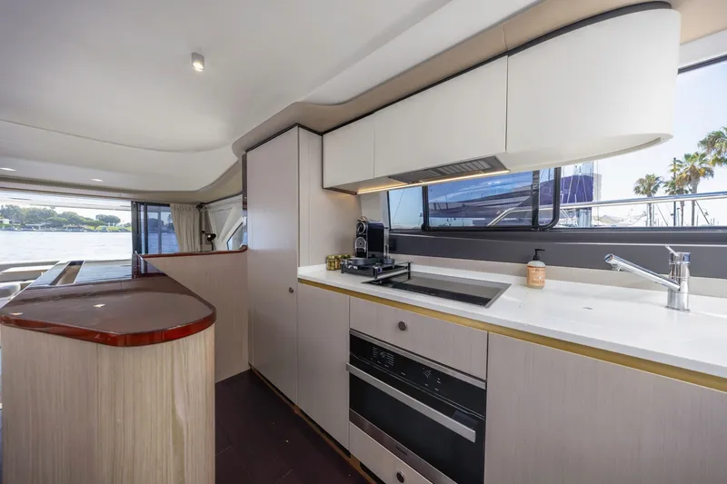 Slide: The Image of Modern kitchen interior on 2021 Azimut Fly 60 yacht, featuring sleek cabinetry and appliances. - 57